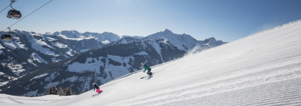 Two skiers going down a piste at a quiet ski resort in France