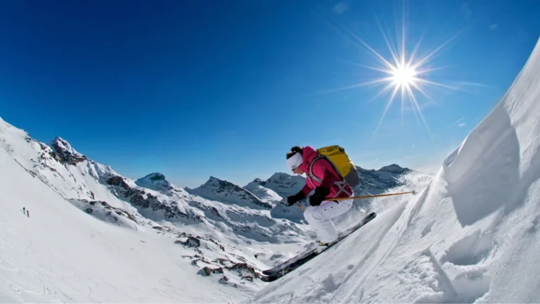 A group of skiers relaxing in front of a view of mountains