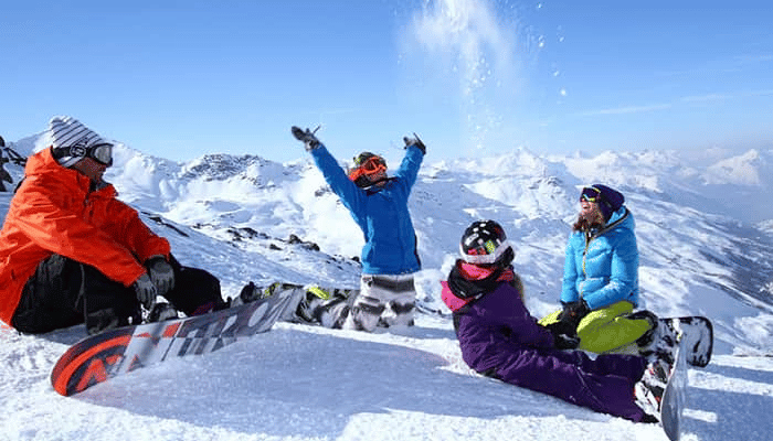 A group of snowboarders having fun on the mountain