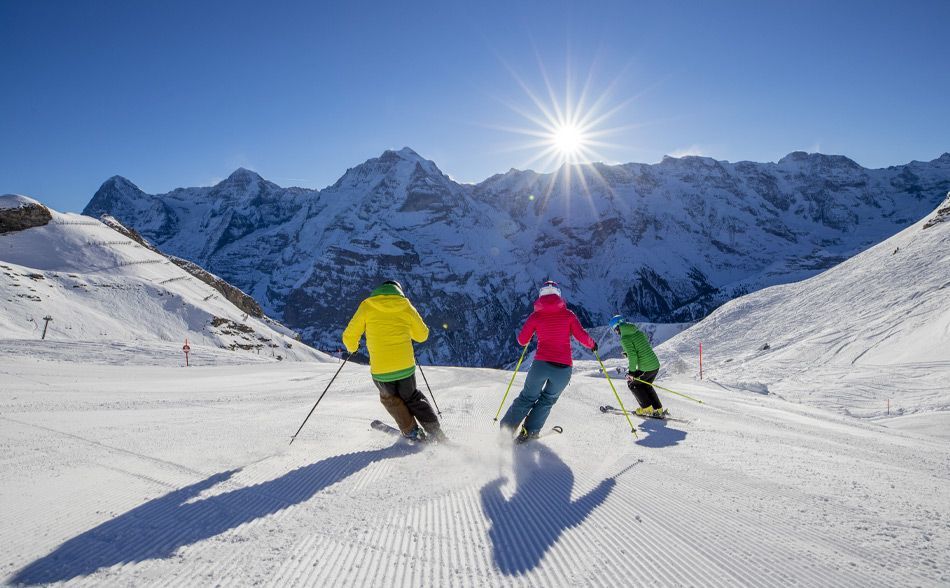 Skiers on the piste during their short ski break in Switzerland