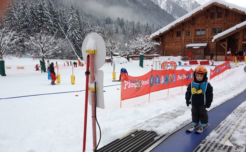 A small child on a magic carpet lift