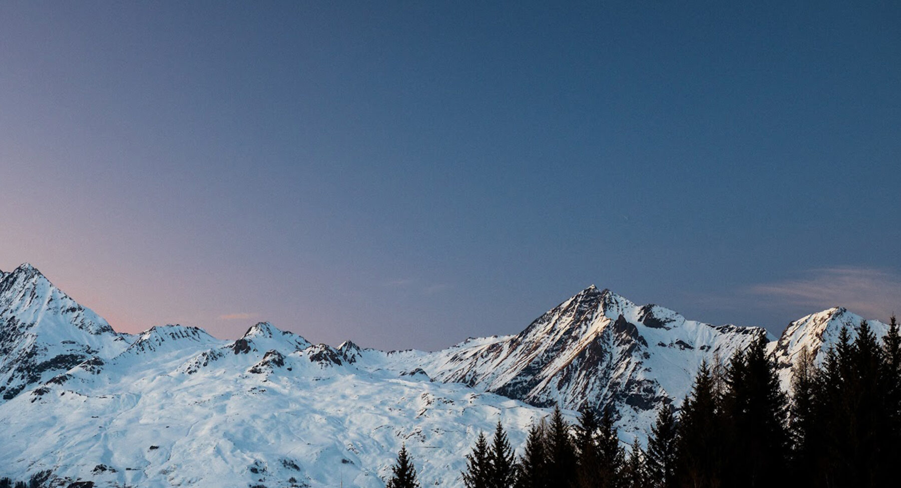 Sunset over the trees and mountains at Les Arcs 2000