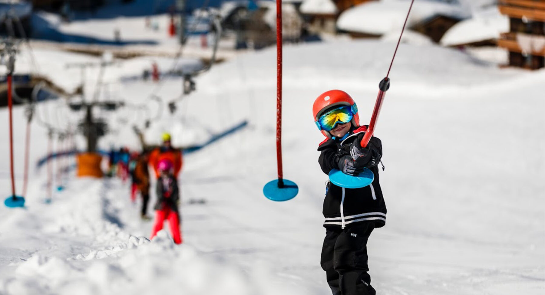 A child on a button ski lift