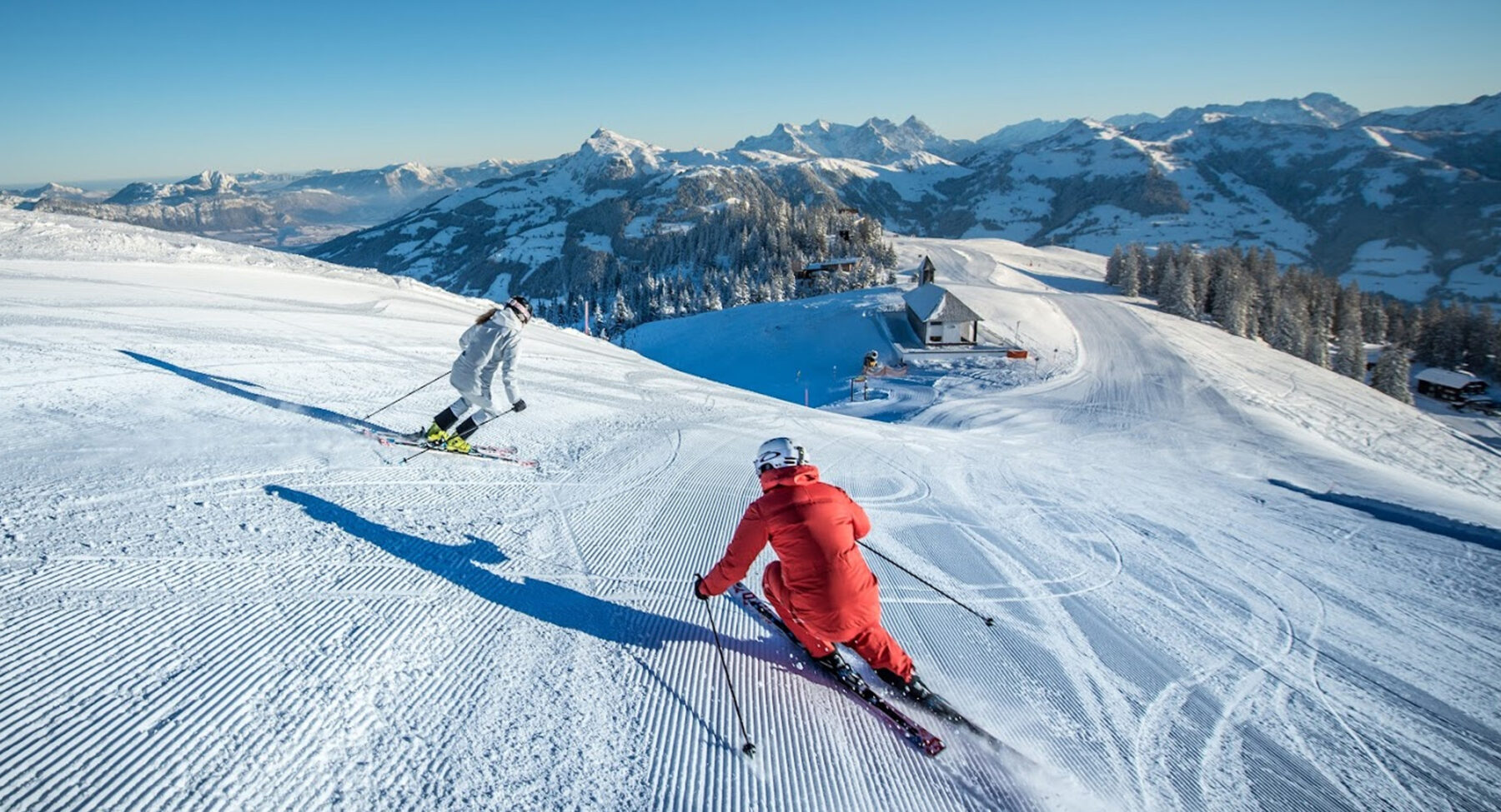 Two skiers on the piste in Kitzbühel