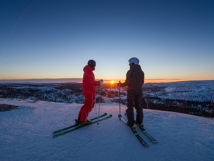 Two skiers at sunset in Trysil