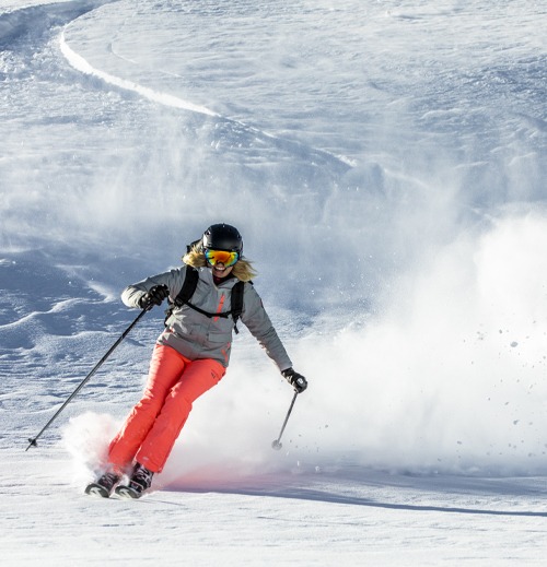 A skier enjoying great snow on the mountain