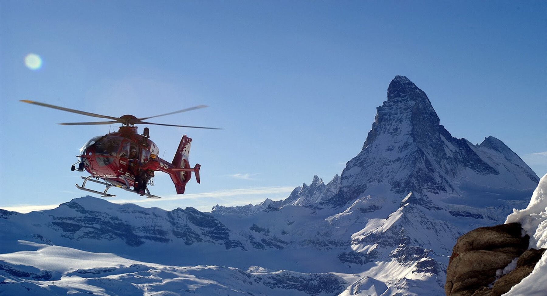 A helicopter in front of the Matterhorn at the luxury ski resort Zermatt