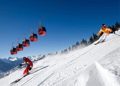 Two skiers skiing down one of the best ski runs in Europe
