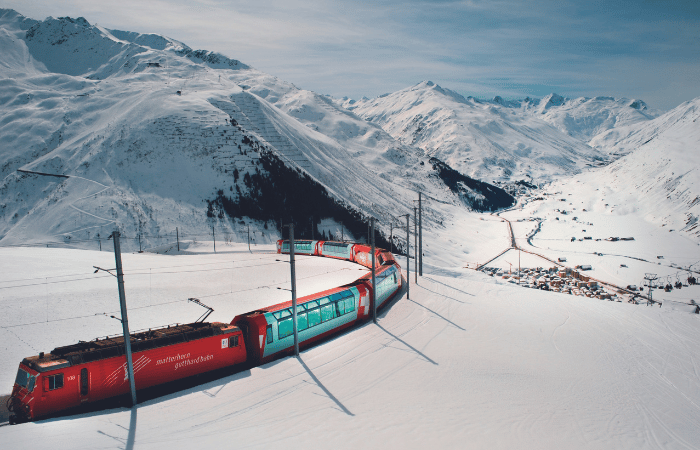A luxury train going through the snowy mountains in Switzerland