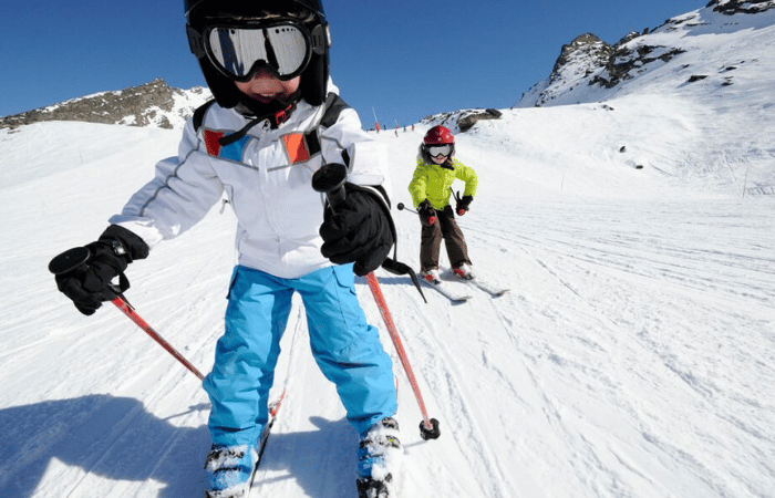 Two children skiing